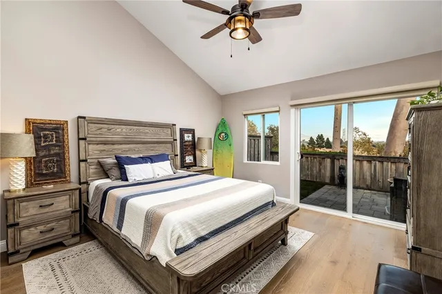 a bedroom with a large bed and a chandelier