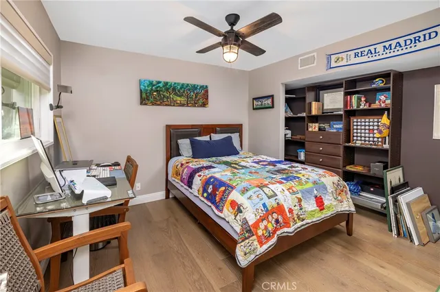 a bedroom with a bed next to a large window