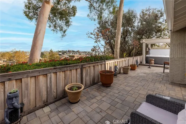 a view of a patio with couches chairs and wooden fence