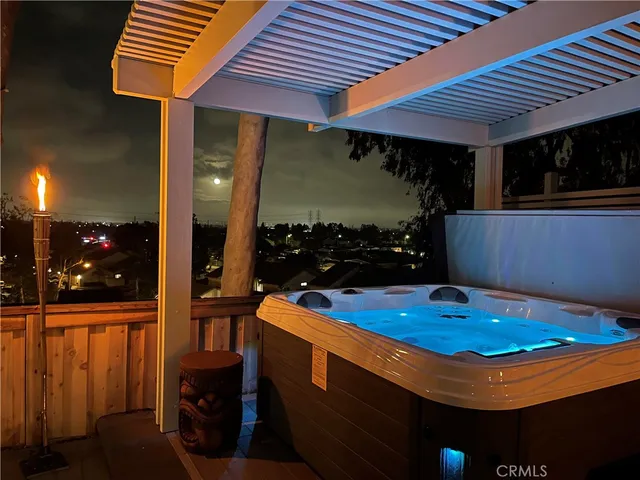 a room with table chairs wooden floor and potted plant