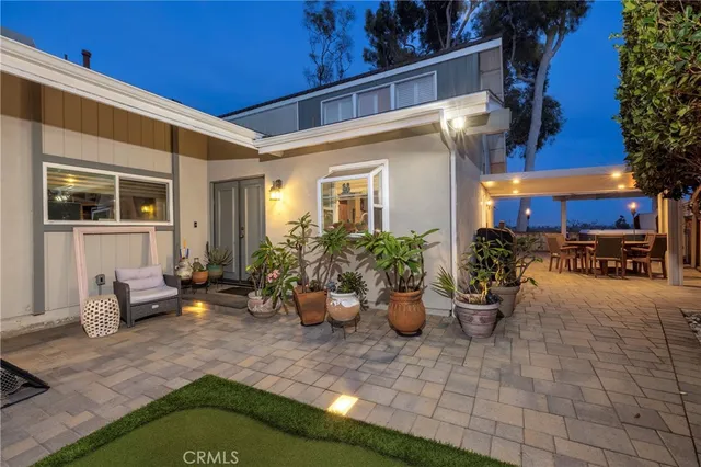 a view of a patio with chairs and plants