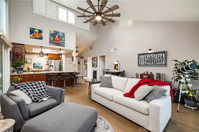 a living room with furniture a couch and a chandelier