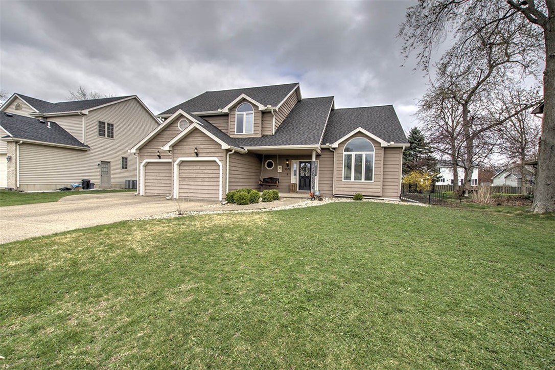 4670 Trevino Lane Decatur, IL 62526 - Photo 2 of 39 a front view of a house with a garden and trees