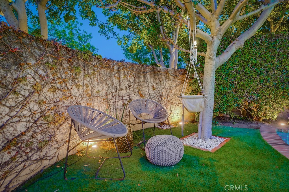 615 Edith Way Long Beach, CA 90807 - Photo 14 of 65 a view of a backyard with plants and a fountain
