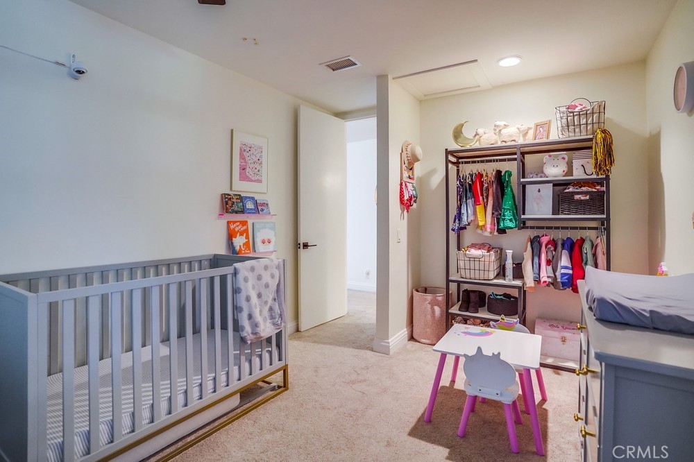 615 Edith Way Long Beach, CA 90807 - Photo 15 of 65 a bedroom with furniture a rug and a book shelf