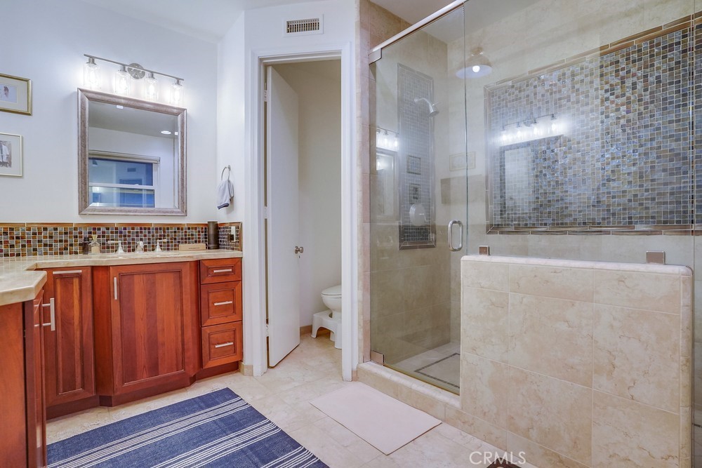 615 Edith Way Long Beach, CA 90807 - Photo 17 of 65 a bathroom with a granite countertop sink mirror and shower