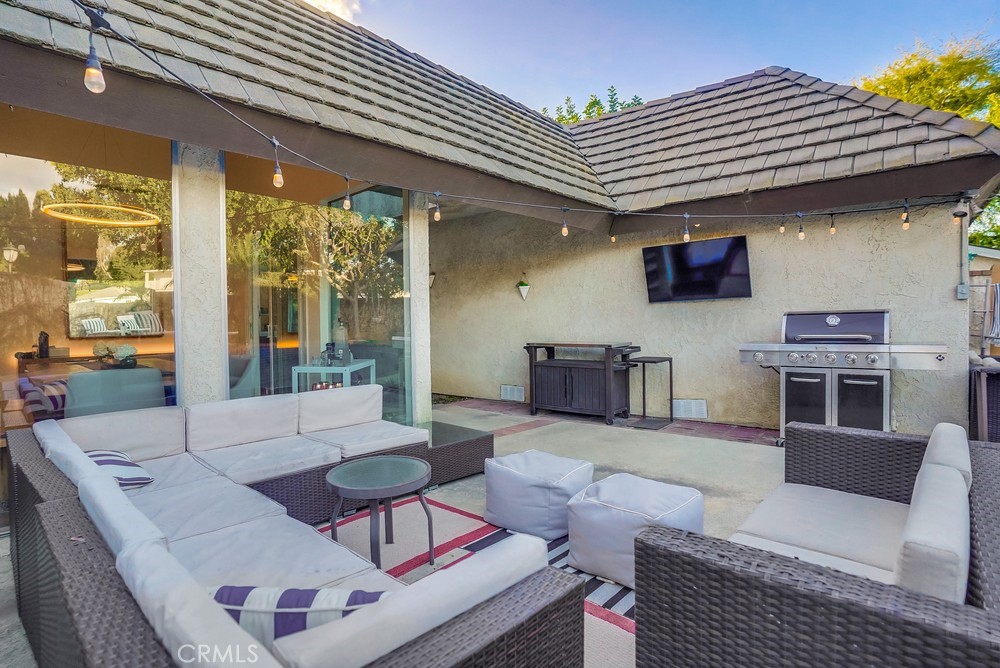 615 Edith Way Long Beach, CA 90807 - Photo 29 of 65 a living room with furniture a flat screen tv and kitchen view