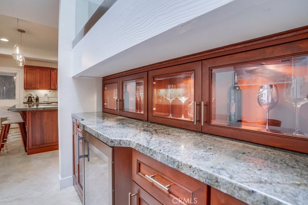 615 Edith Way Long Beach, CA 90807 - Photo 57 of 65 a kitchen with granite countertop a sink and a wooden cabinets