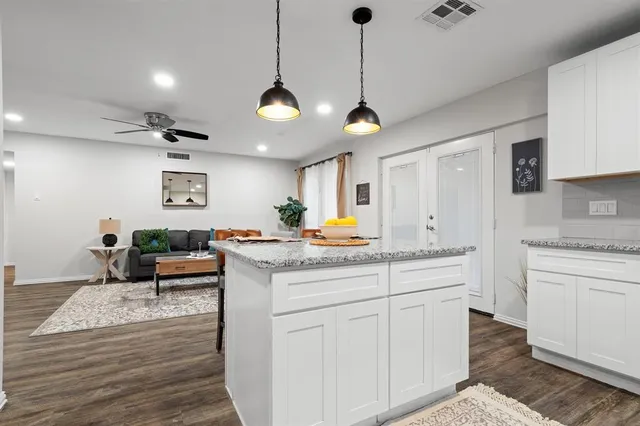 a kitchen with a stove cabinets and wooden floor