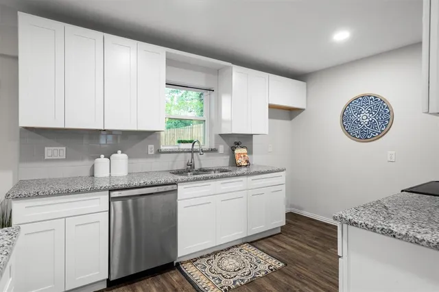 a kitchen with a sink cabinets and window