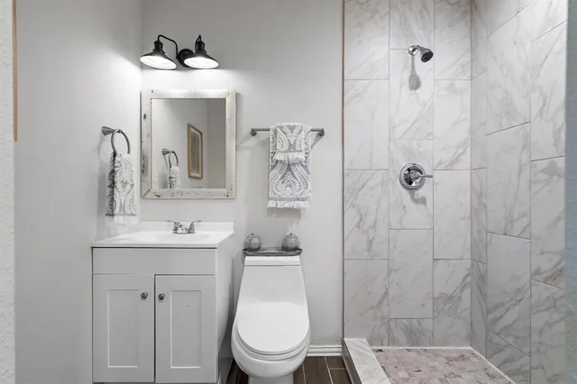 a bathroom with a toilet sink and shower