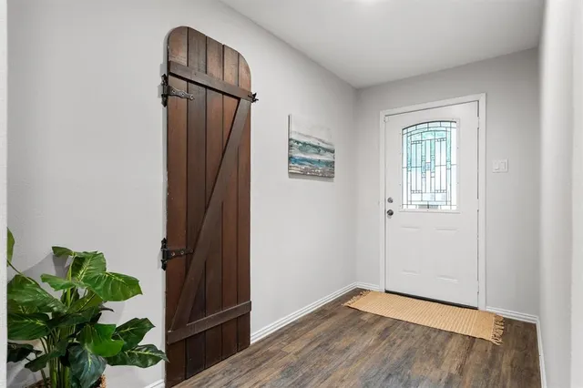 a view of an entryway with wooden floor