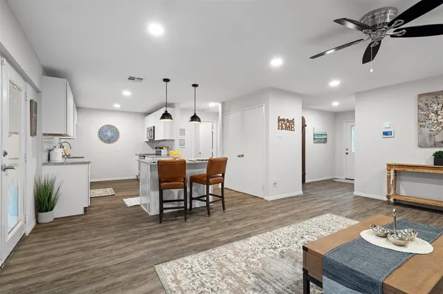 a living room with furniture and wooden floor
