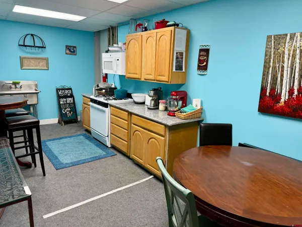 a kitchen that has a sink and a stove in it