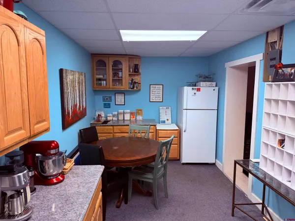 a room with furniture a bookshelf and a refrigerator