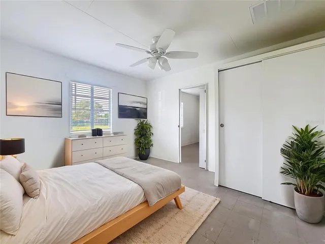a bedroom with a large bed and a chandelier