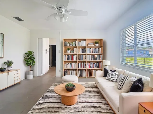a living room with furniture and a potted plant
