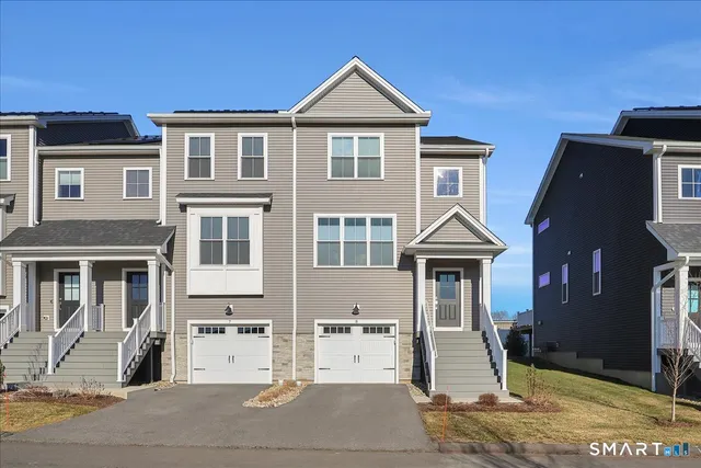 a front view of a house with parking area