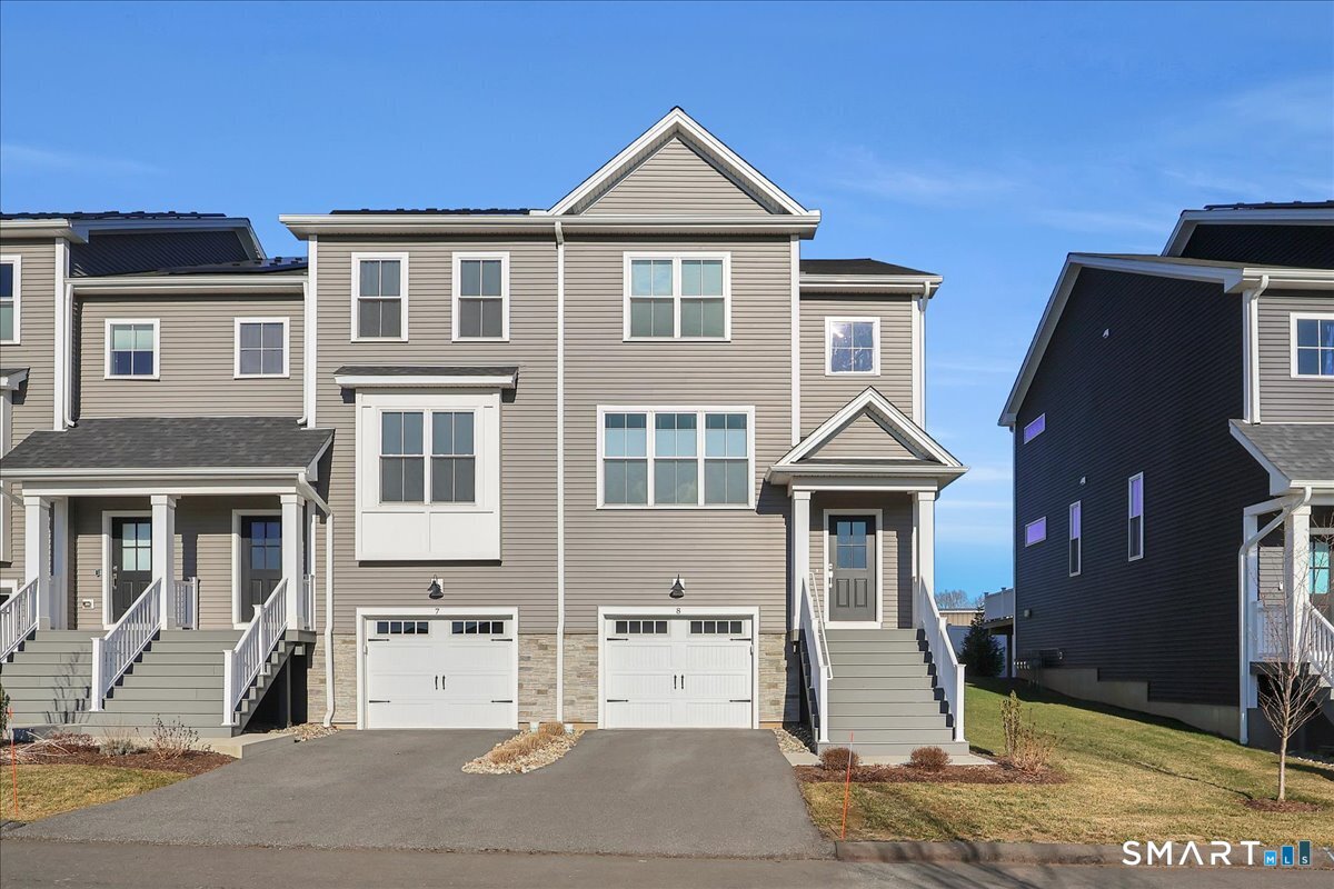 a front view of a house with parking area