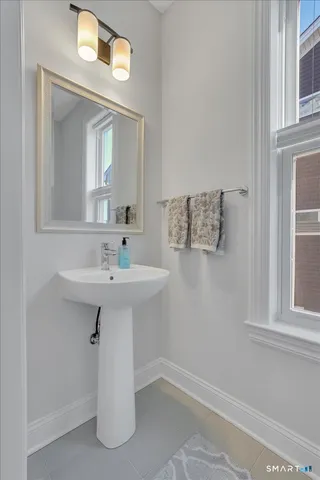 a bathroom with a sink a mirror and a window