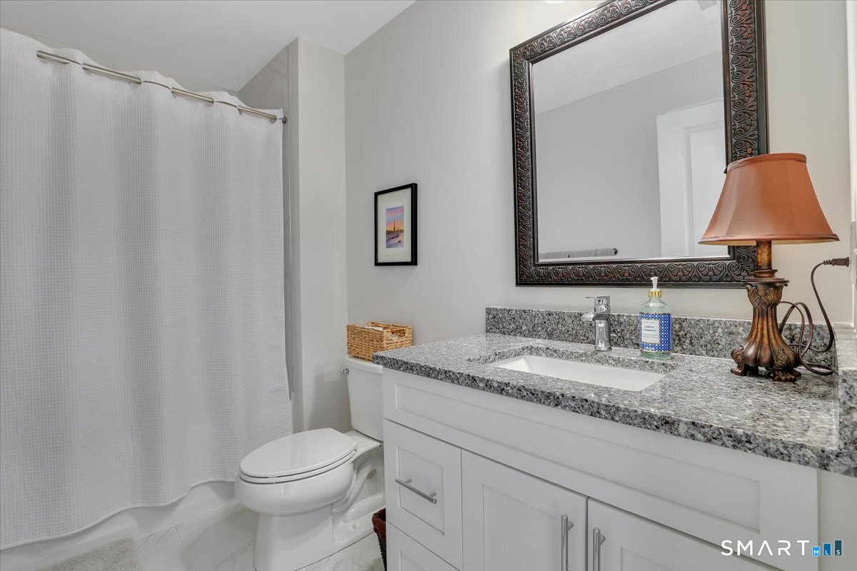 8 Soderman Way, Unit 8 Cheshire, CT 06410 - Photo 20 of 27 a bathroom with a granite countertop sink vanity mirror and toilet