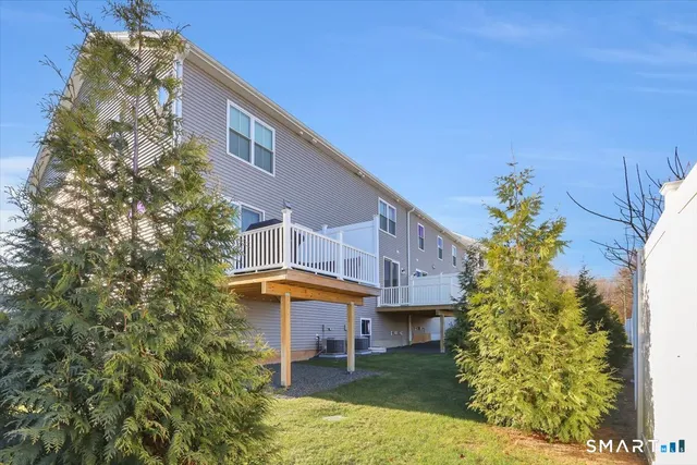 a view of a house with a yard and sitting area