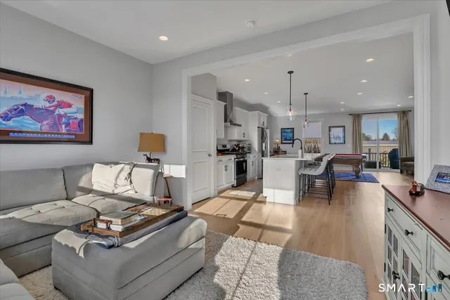a living room with furniture and a dining table with kitchen view