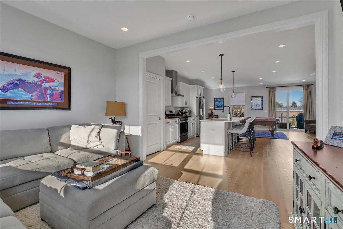 8 Soderman Way, Unit 8 Cheshire, CT 06410 - Photo 4 of 27 a living room with furniture and a dining table with kitchen view