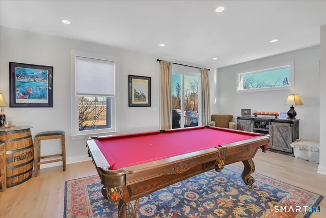 a room with pool table and windows
