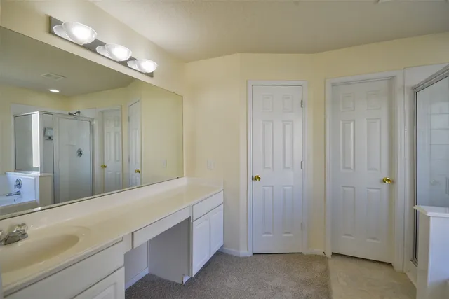 a spacious bathroom with a shower and a sink