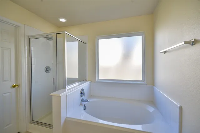 a white bath tub sitting next to a window