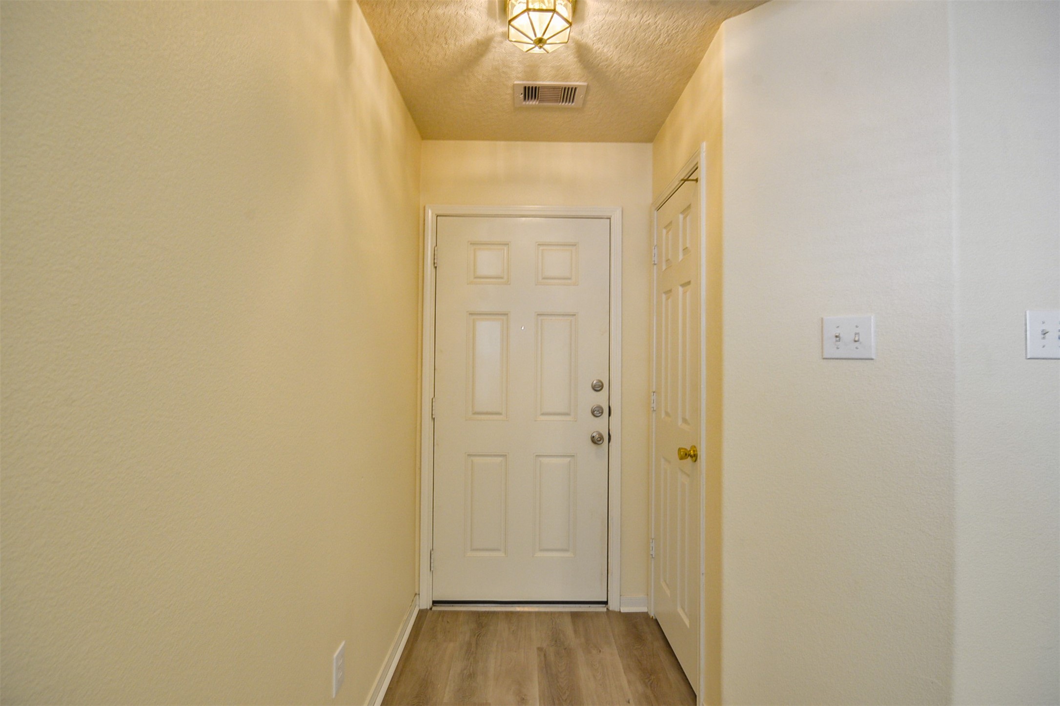 4819 Dappled Grove Trail Humble, TX 77346 - Photo 4 of 20 a view of a hallway with wooden floor