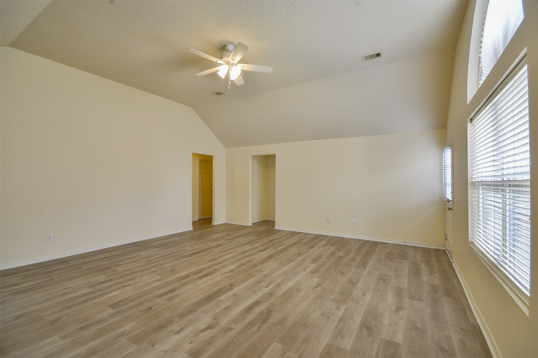 4819 Dappled Grove Trail Humble, TX 77346 - Photo 5 of 20 a view of an empty room with wooden floor and a window