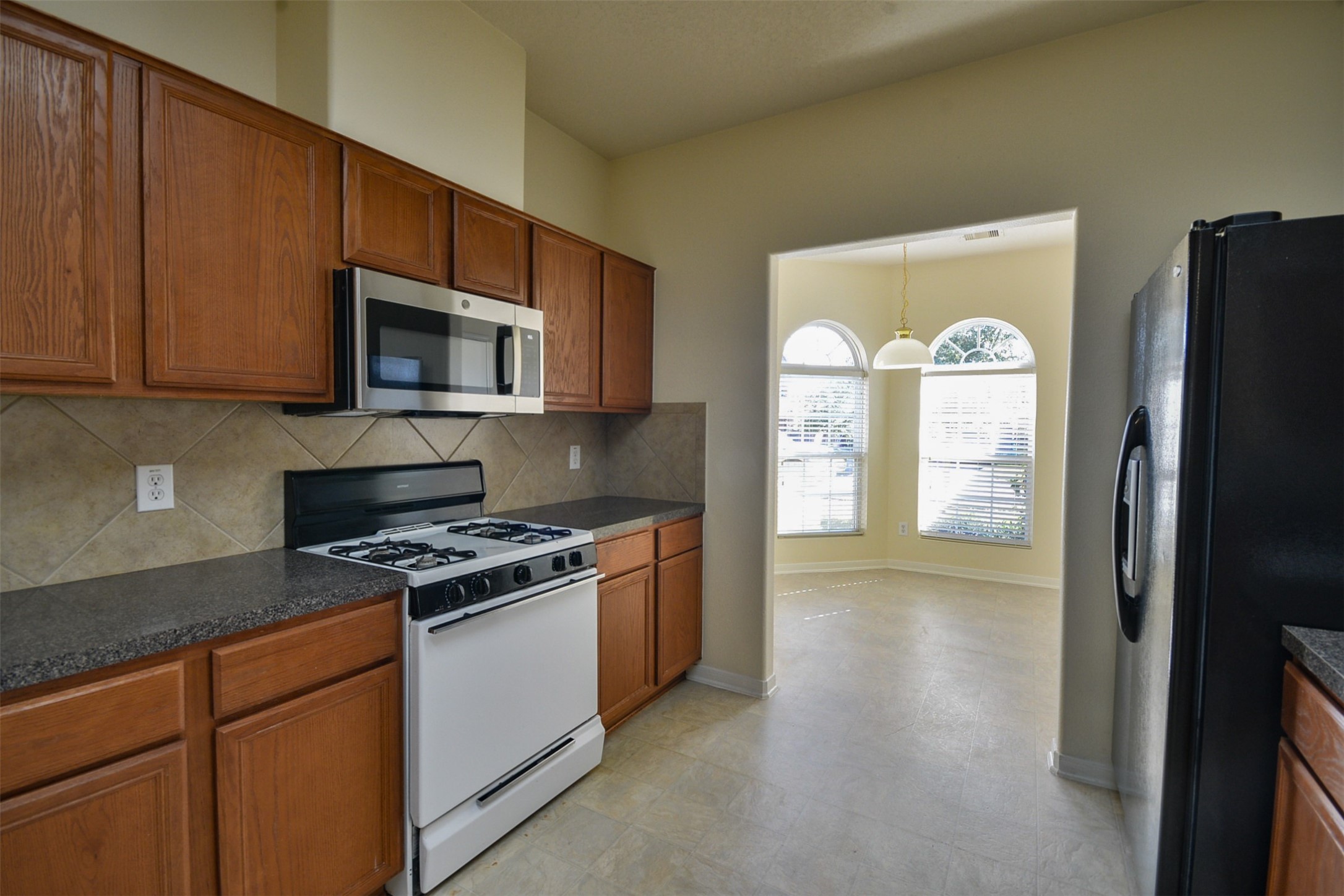 4819 Dappled Grove Trail Humble, TX 77346 - Photo 10 of 20 a kitchen with stainless steel appliances granite countertop a refrigerator stove top oven and sink