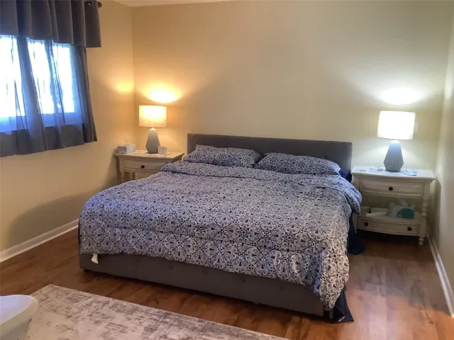 a bedroom with a bed and a lamp with window