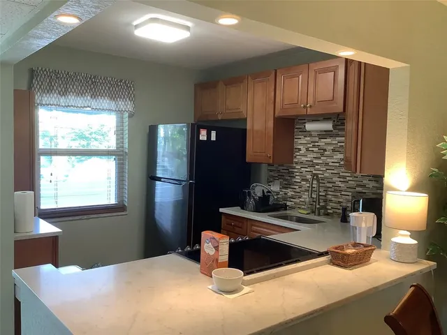 a kitchen with a refrigerator and a sink