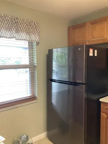 a white refrigerator freezer sitting inside of a kitchen