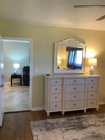 a view of a hallway with a dresser and a mirror
