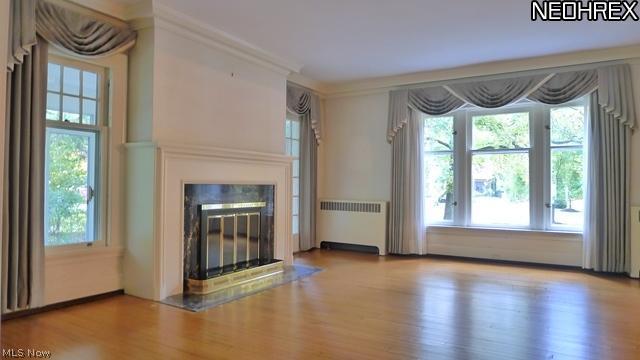 3008 Fontenay Road Cleveland, OH 44120 - Photo 4 of 25 Grand Living Room with thick wood moldings and hardwood floors and a wood burning fireplace