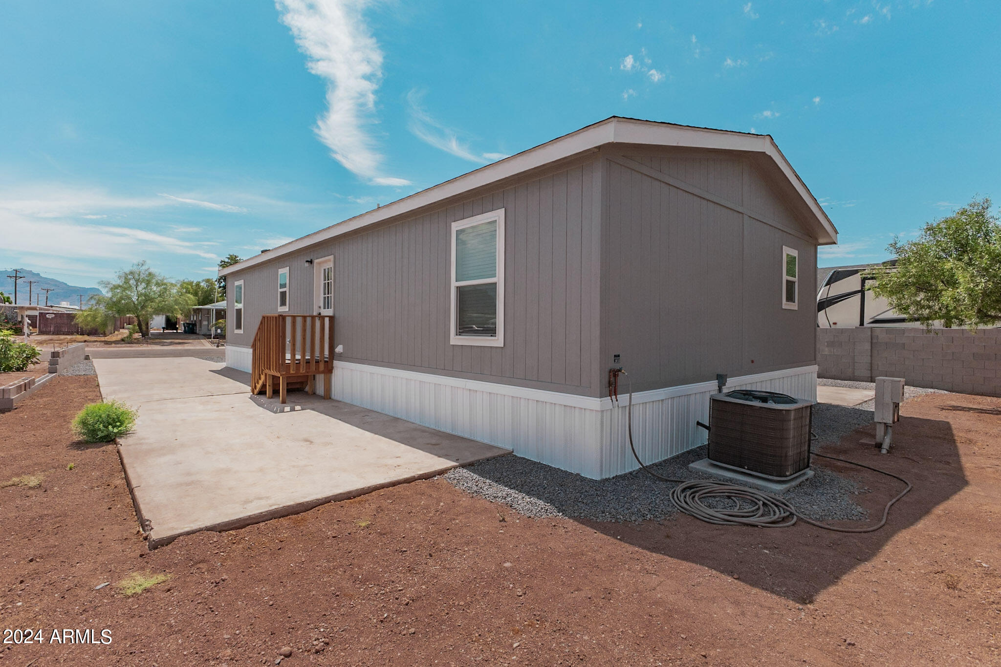 2234 South Descanso Road Apache Junction, AZ 85119 - Photo 23 of 25 a backyard of a house with barbeque oven table and chairs