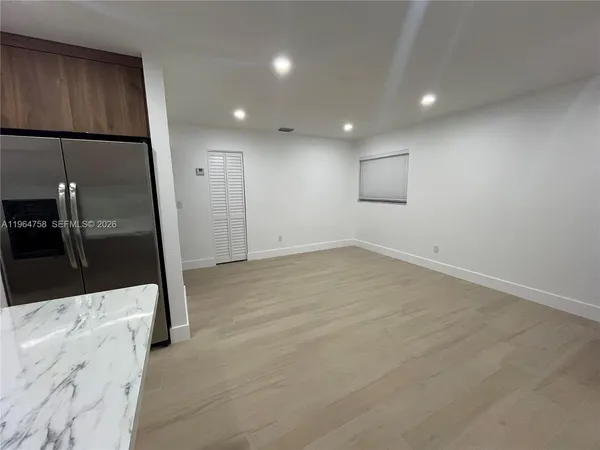 a kitchen with stainless steel appliances wooden cabinets and a stove top oven
