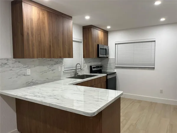 a kitchen with a sink stove and microwave