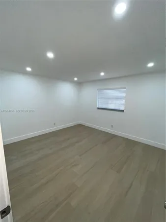 a bathroom with a shower and a glass door