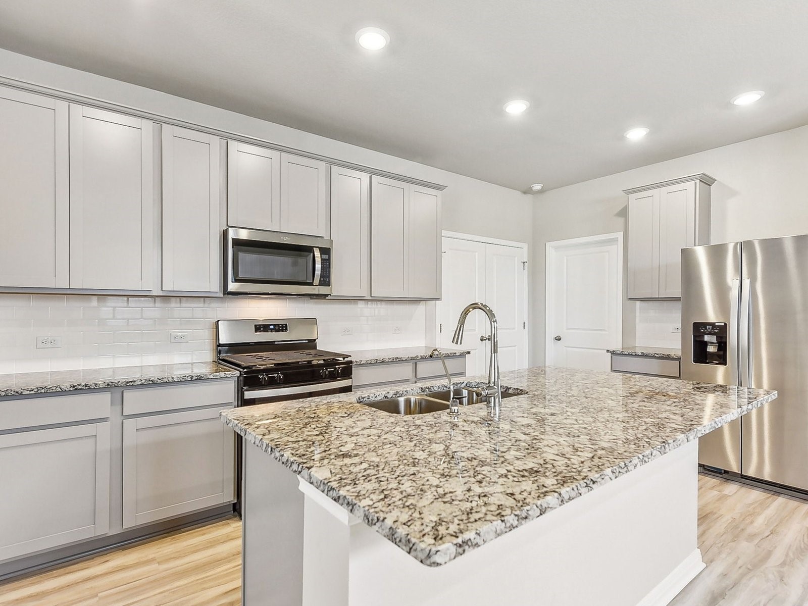 22631 Ellis Way New Caney, TX 77357 - Photo 1 of 13 a kitchen with stainless steel appliances granite countertop a sink stove and refrigerator