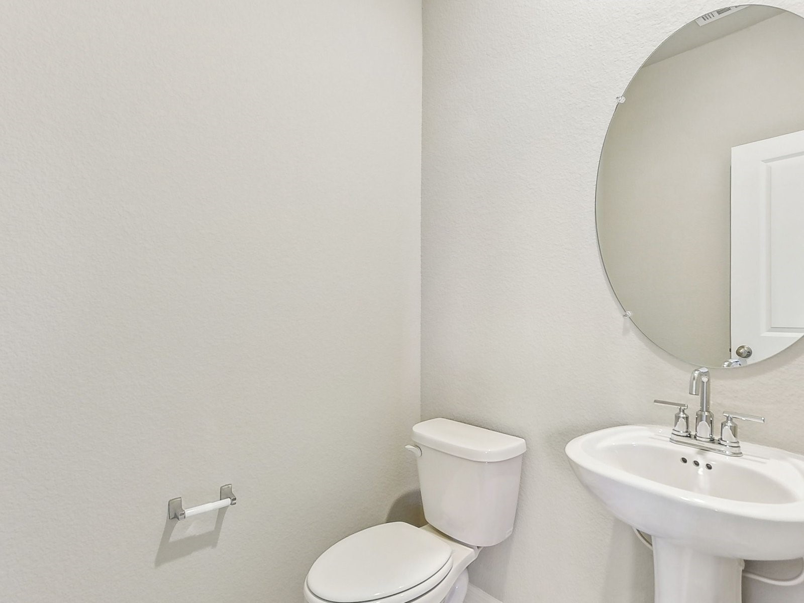 22631 Ellis Way New Caney, TX 77357 - Photo 3 of 13 a bathroom with a toilet sink and mirror