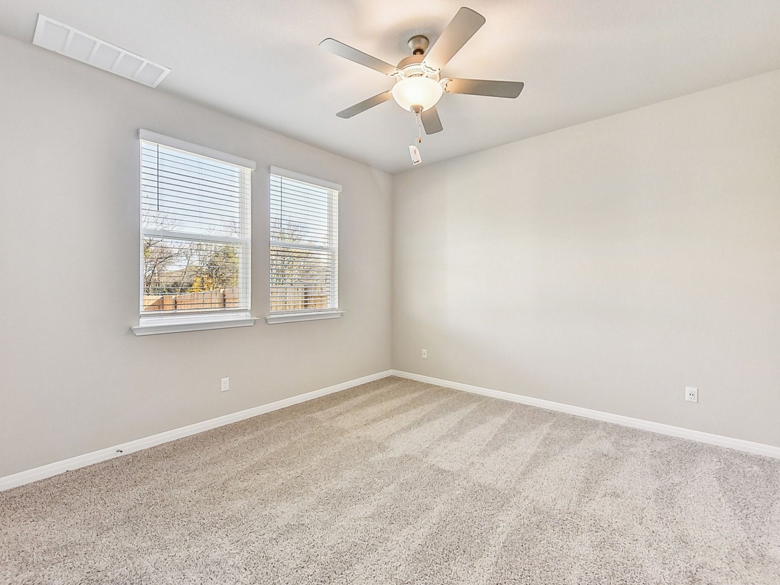 22631 Ellis Way New Caney, TX 77357 - Photo 4 of 13 an empty room with windows and fan