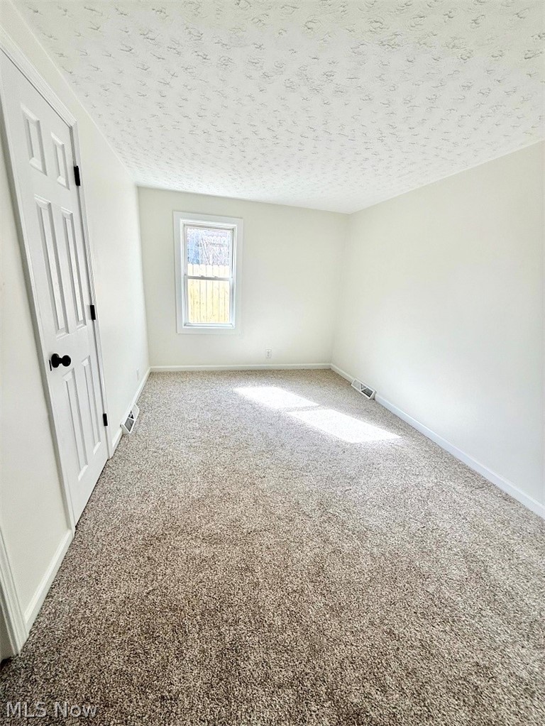 144 Aberdeen Road Steubenville, OH 43953 - Photo 17 of 34 Unfurnished bedroom featuring carpet floors and a textured ceiling