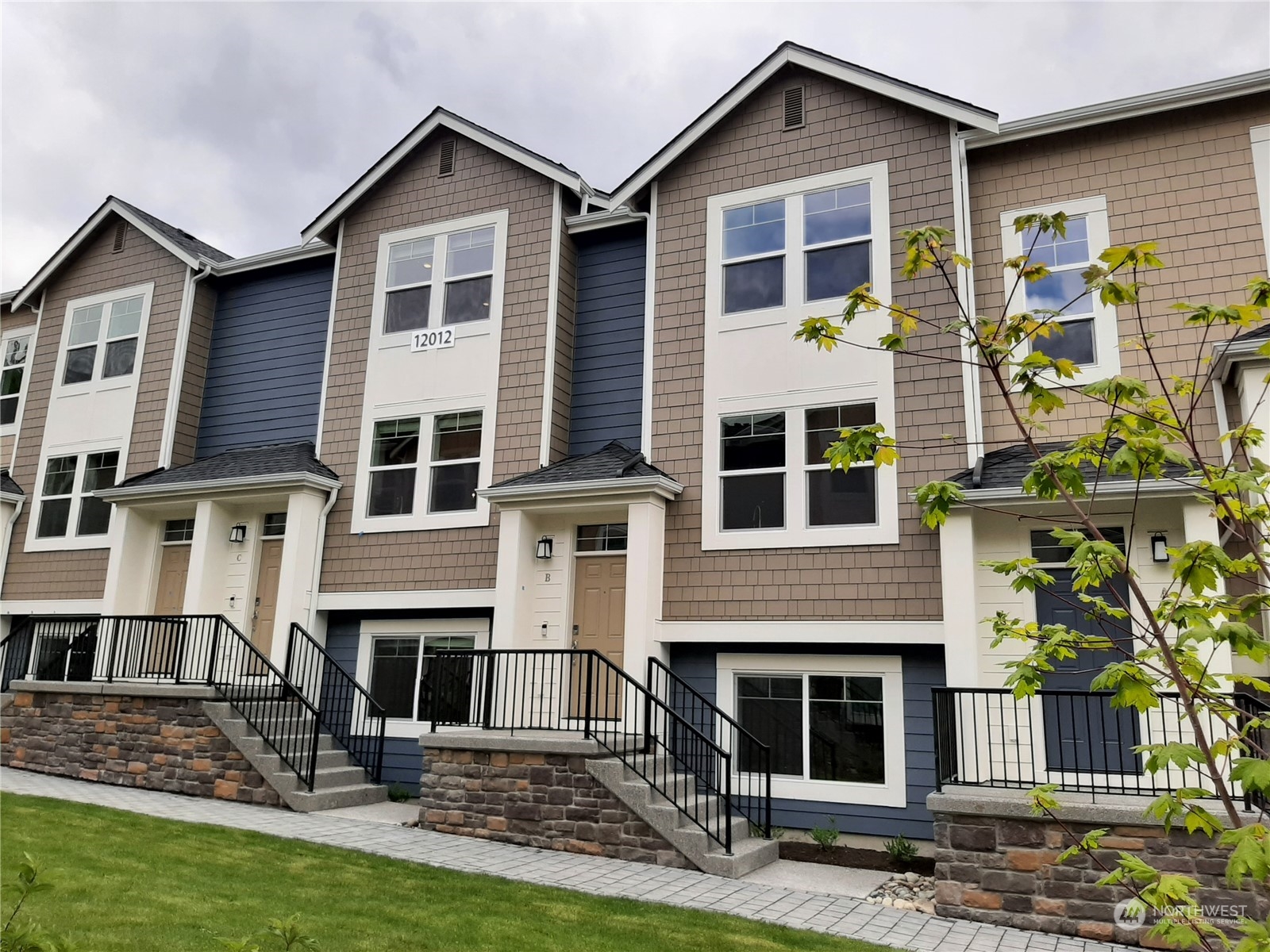 12012 Northeast 193rd Lane, Unit C Bothell, WA 98011 - Photo 1 of 20 a front view of a house with garden