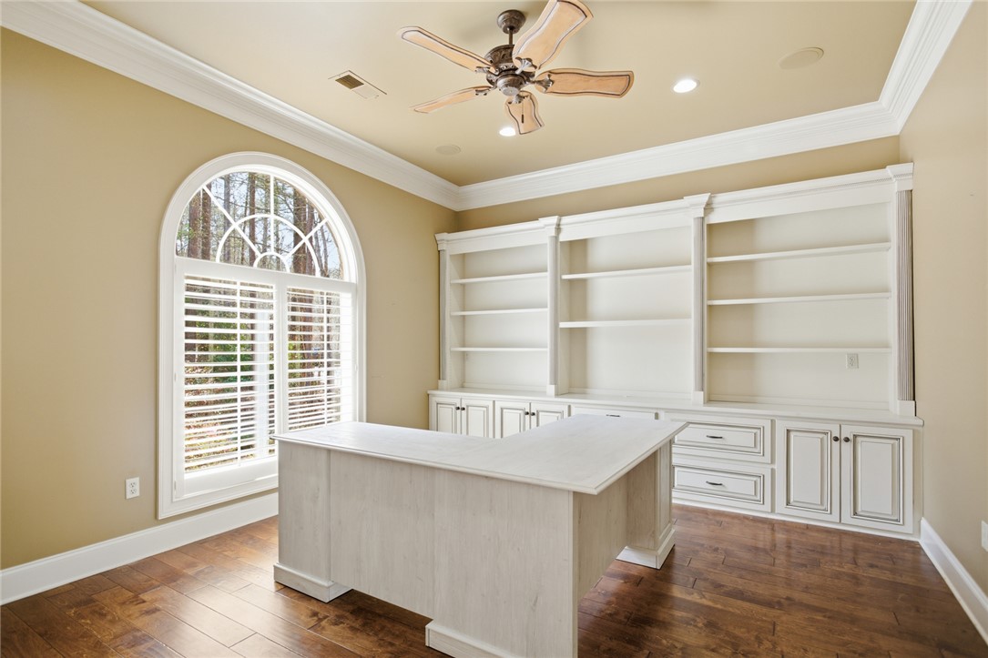 610 Highridge Drive Seneca, SC 29672 - Photo 13 of 50 This bright office space features built-in shelving, rich hardwood floors, and a beautiful arched window.