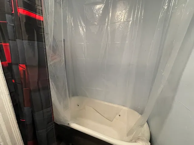 a bathroom with a bathtub and shower